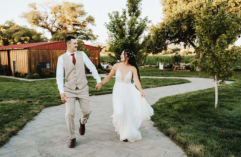 A happy couple starts their first walk at their country wedding at Mortimer Farms in Dewey, AZ.